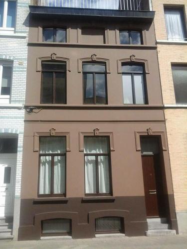 a brown building with windows and a balcony at Budget-Room 2p in Ostend