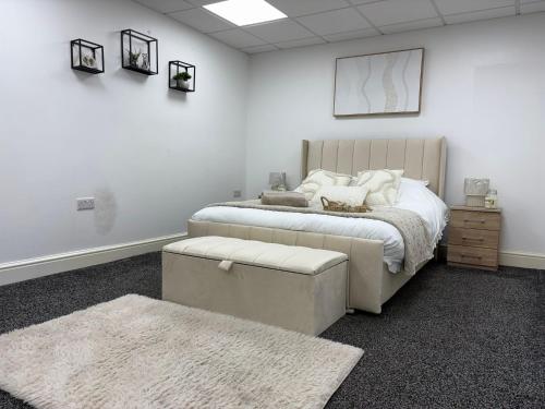 a bedroom with a large bed and a rug at The Shepherd in Hunslet