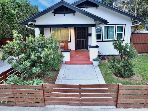 a house with a wooden fence in front of it at Charming Craftsman - Beach Close in Long Beach