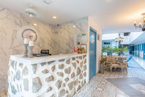 a lobby of a hotel with a stone wall at Hotel Adaz Mediterráneo in Santa Marta