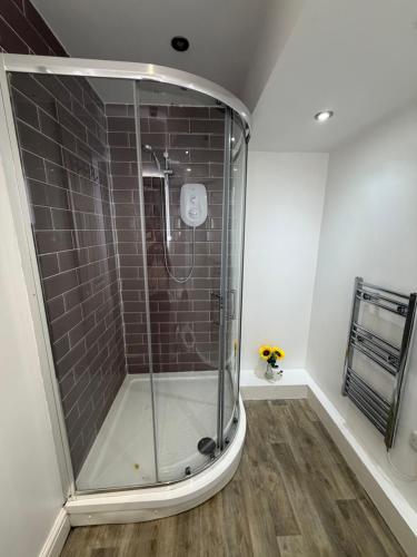 a shower with a glass door in a bathroom at The Shepherd in Hunslet