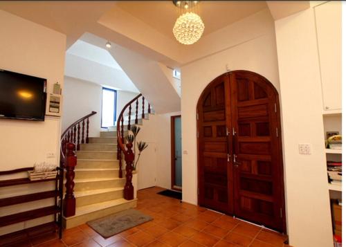 a hallway with a staircase and a wooden door at Fuyue Sea View B&B in Taitung City