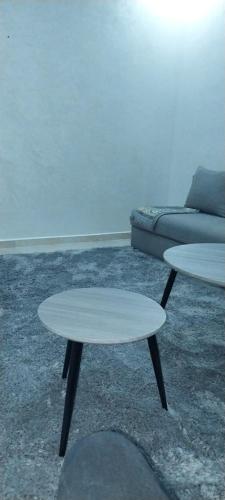 a living room with two tables and a couch at rooms maissa 1 in Cabo Bojador