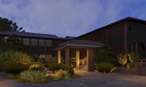 a large black building with a lot of windows at Onyado Satsuki in Tamana