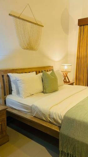 a bedroom with a bed with a chandelier above it at Villa Searenity Seminyak in Seminyak
