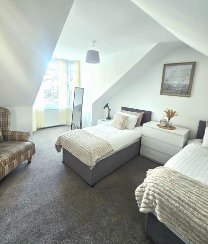 a bedroom with two beds and a couch at The Coal House in Townhill
