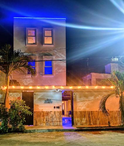 a house with lights on the front of it at Cancun Hostel in Cancún
