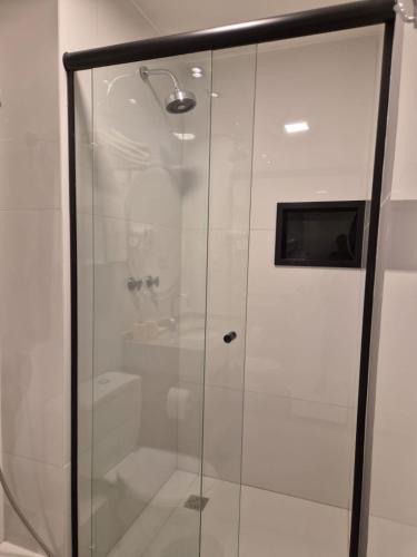 a shower with a glass door in a bathroom at Gran Lençóis Flat Residence Mandacaru 411 in Barreirinhas