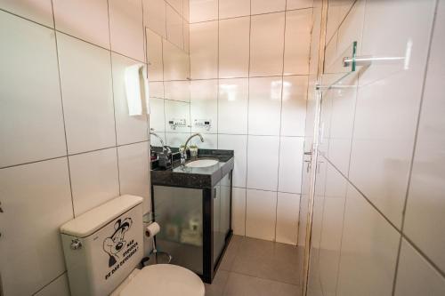 a bathroom with a toilet and a sink and a shower at Refúgio Black in Sabará