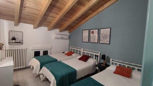 a bedroom with two beds in a room at Villa Pachita (por habitaciones) in Alhama de Aragón