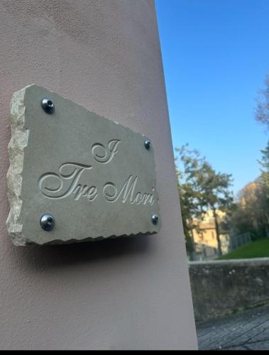 a metal sign on the side of a building at I Tre Mori in Recanati