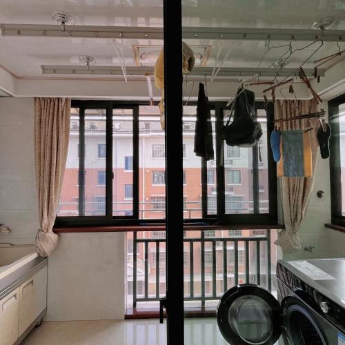 a kitchen with a large window and a balcony at 青云小栈 in Shaoxing