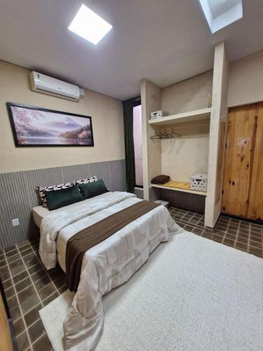 a bedroom with a large bed in a room at Origami in Palmas