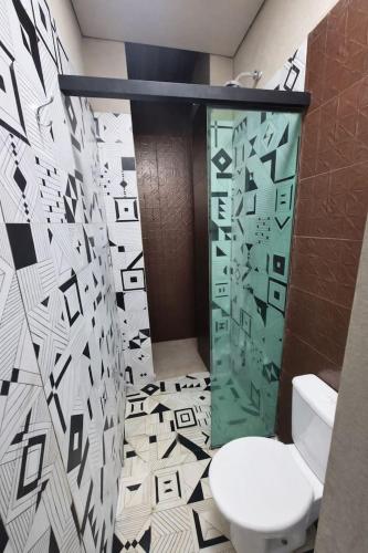 a bathroom with a toilet and a glass shower at Origami in Palmas