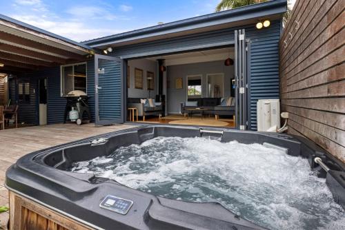 a jacuzzi tub sitting on a patio at Bluetongue at Culburra I Pet Friendly 4 Mins to Beach in Culburra Beach