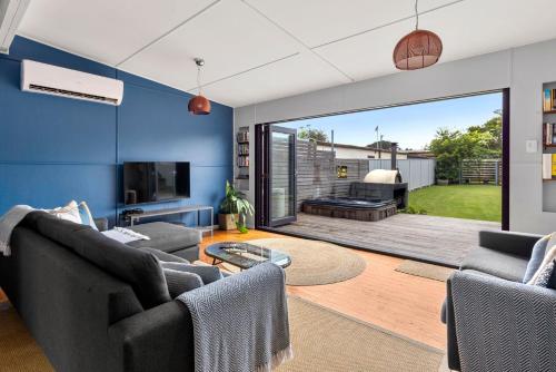 a living room with two couches and a large sliding glass door at Bluetongue at Culburra I Pet Friendly 4 Mins to Beach in Culburra Beach