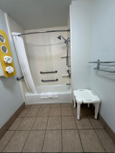 a small bathroom with a shower and a toilet at EXPRESS INN Troy in Troy