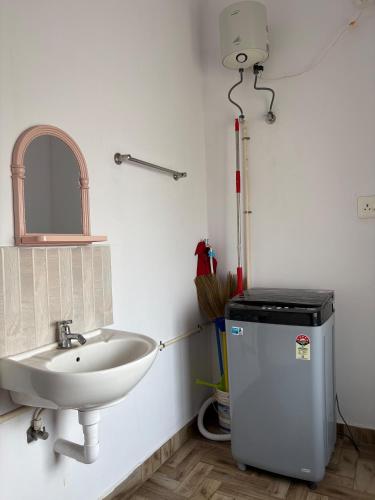 a bathroom with a sink and a mirror at Anchery homes in Trichūr