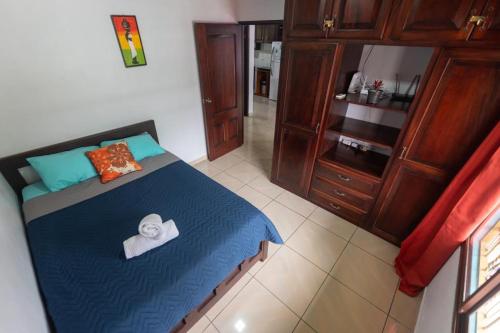 a bedroom with a bed with a towel on it at Villa Arenal Volcano & Privade pool in Fortuna