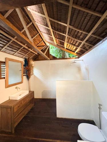 a bathroom with a sink and a toilet at The Angkayo in Angkayo