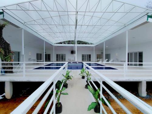 a large white room with plants on the floor at Zoobic Glampz in Subic
