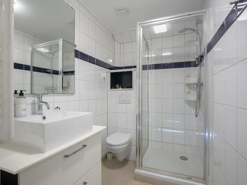 a bathroom with a shower and a toilet and a sink at Getaway with Bikes & Whirlpool in Grou