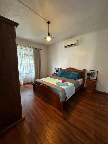 a bedroom with a bed and a wooden floor at OC Villa in Calodyne