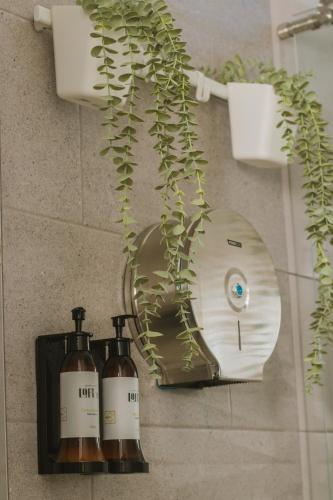 a bathroom with two bottles of soap and a mirror at Aparta Hotel Loft 1985 in Puerto Gaitán