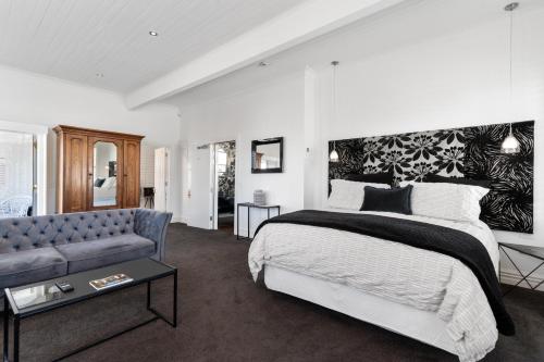a bedroom with a bed and a couch at Altitude Studio in Martinborough