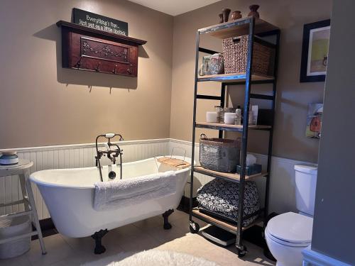 a bathroom with a white bath tub and a toilet at Mountain Guesthouse Bed and Baking in Radium Hot Springs