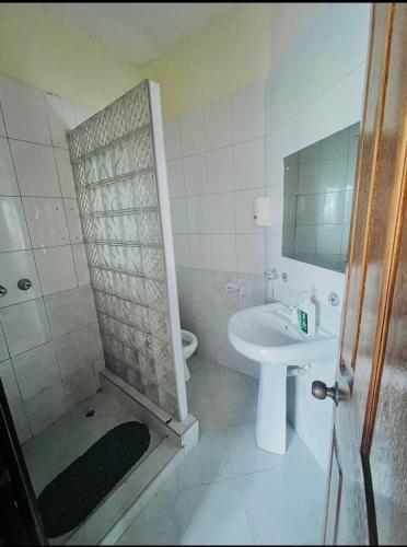a bathroom with a shower and a sink and a toilet at Sunrise-Nyali, Mombasa in Nyali