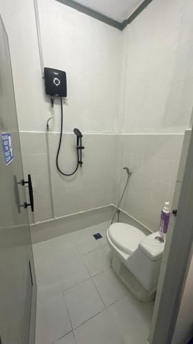 a bathroom with a toilet and a shower stall at First Avenue Male Hostel BSB in Bandar Seri Begawan