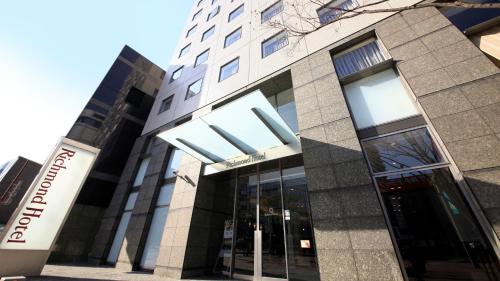 a building with a sign in front of it at Richmond Hotel Fukuoka Tenjin in Fukuoka