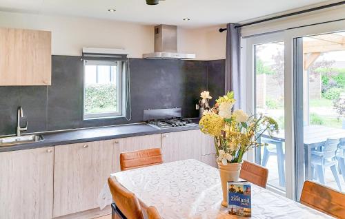 a kitchen with a table and a stove top oven at 3 Bedroom Nice Home In Heinkenszand in Heinkensand