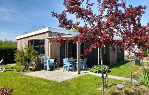 a house with a table and chairs in a yard at 3 Bedroom Nice Home In Heinkenszand in Heinkensand