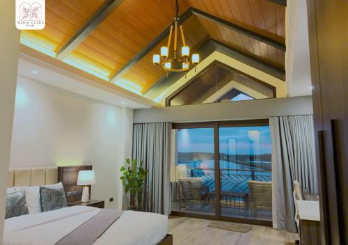 a bedroom with a large bed and a balcony at Maria Clara Villas in Panabo