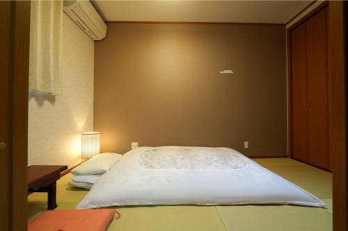 a bedroom with a large bed and a table at 京都佳月民宿 in Kyoto