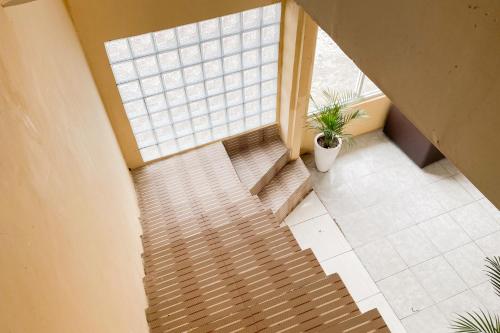 an overhead view of a staircase with a window at RedDoorz at Hotel Warna Palopo in Palopo