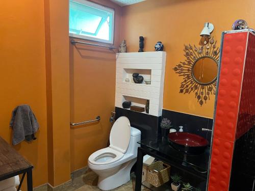 a bathroom with a toilet and a sink at Charming quirky Thai style house in Hua Hin