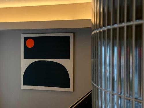 a picture on the wall in a room at Clio Matoba by b hotel - Classic Studio with Kitchen near Station in Ōsukachō