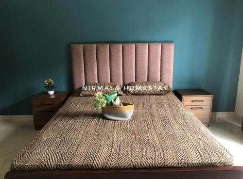 a bedroom with a bed with a potted plant on it at Nirmalahomestay in Polgasowita