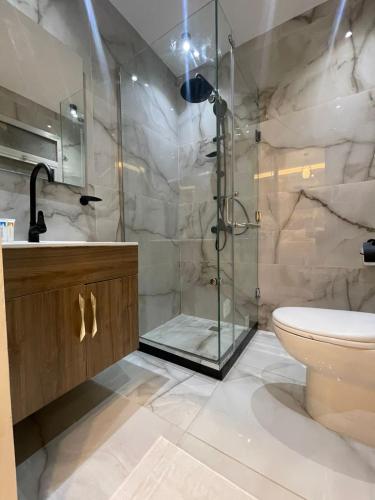 a bathroom with a shower and a toilet at Golden House Madinty in Madinaty