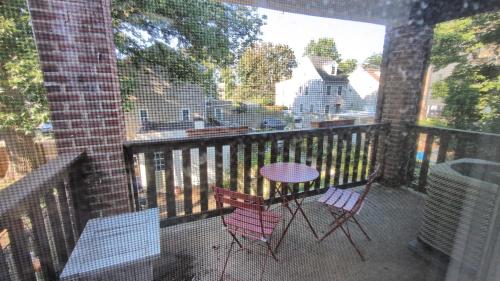 two chairs and a table on a balcony at Rooftop GreeneHouse Suite in Philadelphia