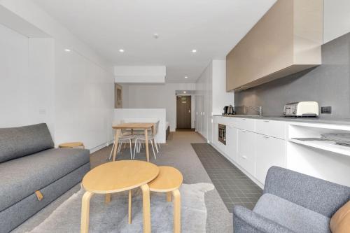 a living room with a couch and a table at Squatters Run 26 in Thredbo