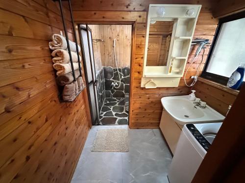a bathroom with a shower and a sink at Mori Vila Aso in Takamori