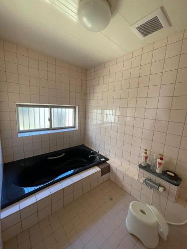 a bathroom with a bath tub and a toilet at Jurakuji - Vacation STAY 15239v in Awa