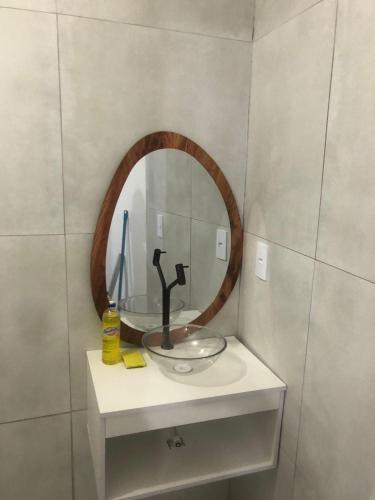 a bathroom with a sink and a mirror at Pousada da Neném - Quarto Tangerina in Campina Grande