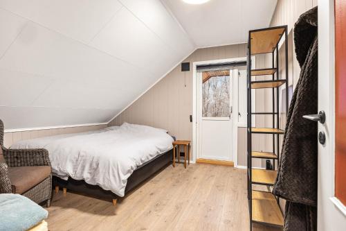 a small bedroom with a bed and a ladder at Aurora Lodge in Bjørnevatn