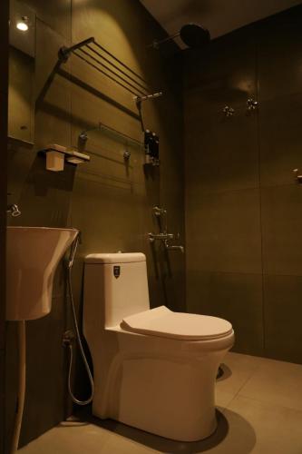 a bathroom with a toilet and a sink at Majesty inn in Bangalore