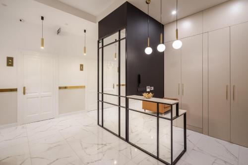 a room with a counter and a hallway with white cabinets at Budapest Cereja Boutique in Budapest